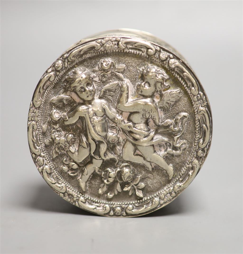 A late 19th/early 20th century German embossed 800 white metal circular box, with hinged cover, 9.5cm, 6oz.